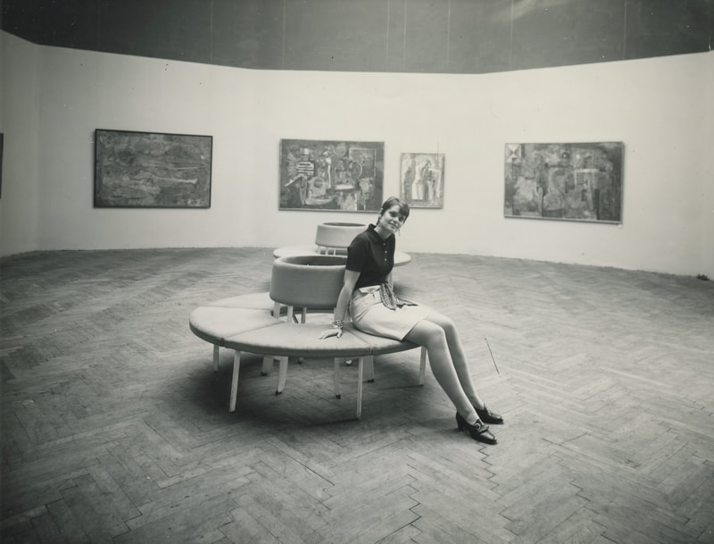 Black and white photo of Carla sitting in a gallery during the Venice Biennale, 1968.